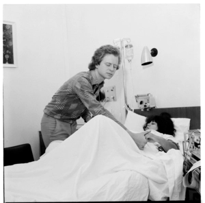 Photographs in a hospital, a woman in labour
