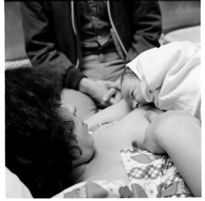 Woman and her newly-born baby in a hospital theatre