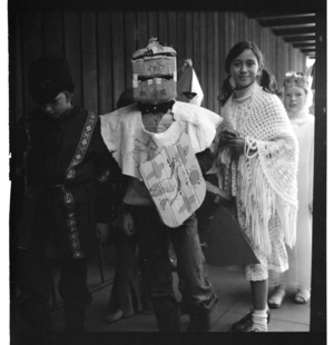 Karori West Normal School children wearing medieval-styled costumes, parading into the school