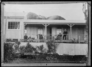 Group on the verandah of the caretaker's house, at Dawson Falls, Mount Taranaki - Photograph taken by David Duncan