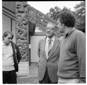 Outside the meeting house at Pipitea Marae during a Māori art exhibition, and, in a room with Māori children looking a carving