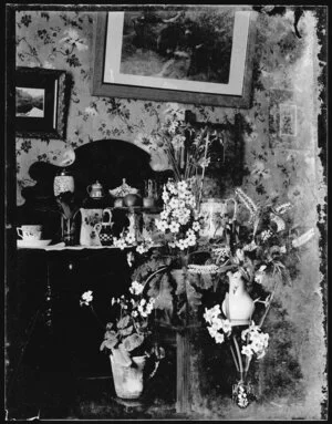 Interior with hebe, primula, daffodils on dresser