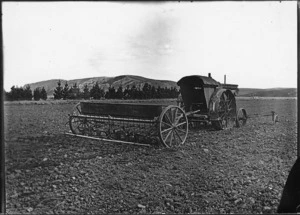 Tractor, seed drill, and tine harrow in field