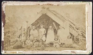 Maori family outside a whare puni at Mangaakuta, near Masterton