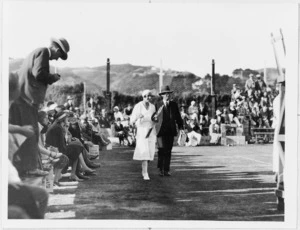 Female tennis player and man walking beside court at Miramar, Wellington