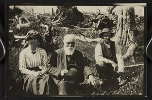 Lady Anna Paterson Stout, Sir Robert Stout, and an unidentified man sitting on a bank