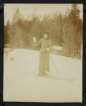 Constance on skis on a snow covered slope with trees behind