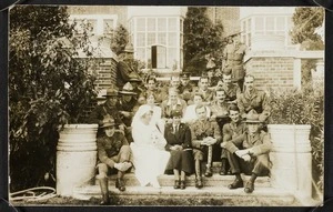 Agnes Isobel Pearce (later Stout) with nurses and soldiers on the steps of a large brick building