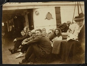 Group of men and women sitting on the deck of a ship, possibly including members of the Pearce family