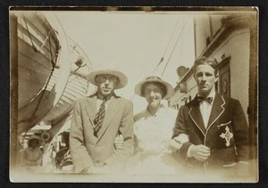 Unidentified man and woman with a younger man on board a ship