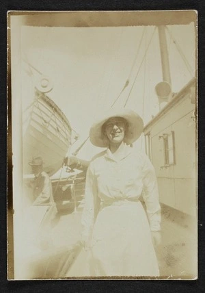 Unidentified woman standing on the deck of a ship