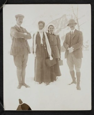 Two men and two women standing in the snow