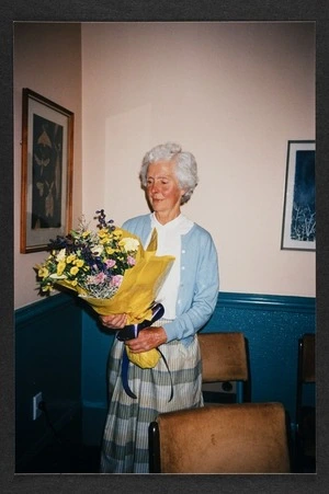 Dr Vida Mary Stout holding a bouquet of flowers