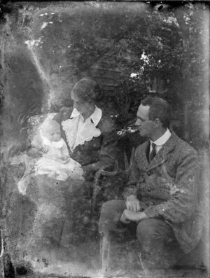Man, woman and baby in garden