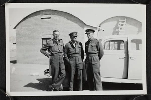 Thomas Duncan McGregor Stout with two other men in army uniform standing beside a car, Palestine.