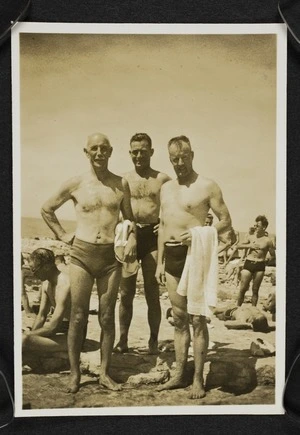 Thomas Duncan McGregor Stout with two unidentified men on a crowded beach