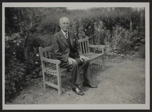 Thomas Duncan Macgregor Stout sitting on a park bench