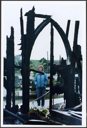 Sue Sutcliff in front of the charred ruins of Rangiatea Church, Otaki - Photograph taken by Phil Reid