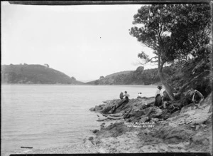 Women exploring the rocky foreshore, Awaawaroa Bay, Waiheke Island