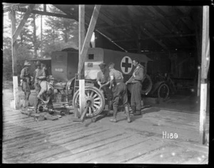 Soldiers repairing a wheel from a hospital vehicle during World War I