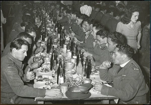 Returned members of the 28th (Maori) Battalion eating a meal