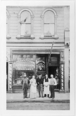 Group in front of the hairdresser and tobacconist shop L P Christeson on Willis Street, Wellington
