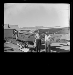 Two unidentified men beside Marlborough Aero Club Auster J/1B Aiglet (ZK-BDQ) aircraft