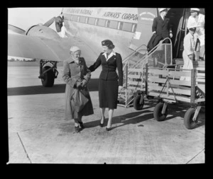 National Airways Corporation (NAC) stewardess Val Grant and an unidentified old lady at Whenuapai Aerodrome, Waitakere, Auckland