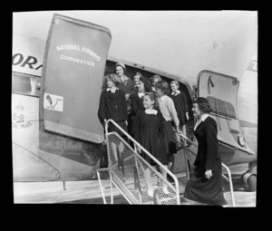 National Airways Corporation (NAC) stewardess Valerie Grant with unidentified school children, Whenuapai Aerodrome, Waitakere, Auckland