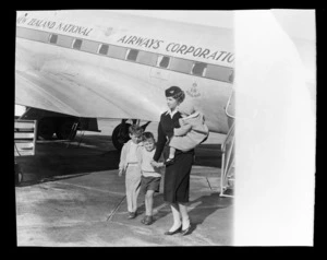 National Airways Corporation (NAC) stewardess Sandra Wakeman and unidentified children, Whenuapai Aerodrome, Waitakere, Auckland