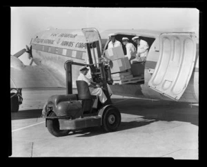 National Airways Corporation (NAC) worker loading freight with a fork lift truck, Whenuapai Aerodrome, Waitakere, Auckland