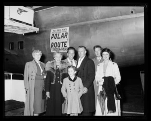 Unidentified group of finely dressed passengers beside air stairs on plane with sign for Pan American World Airways (Pan Am) Polar Route flying from London and Paris on its fuselage