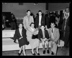 Well dressed group of passengers, including [Leo Lemuel White?], in gate lounge [prior to flight on Pan American World Airways (Pan Am) Polar Route?]
