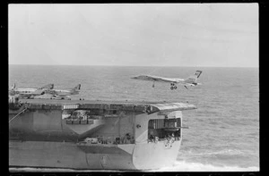 Aircraft carrier Enterprise with Vigilante bomber flying above