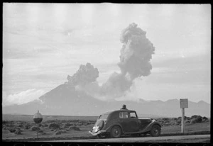 Man watching Mt Ngauruhoe eruption from Desert Road