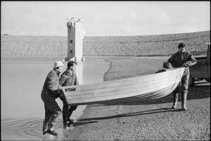 Engineers lifting a boat out of the smaller of two water storage lakes at Te Marua - Photograph taken by Ross Giblin