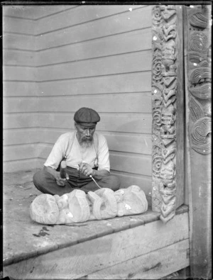 Maori man carving wooden figure - Photograph taken by William Henry Thomas Partington