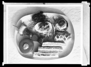 Plate of food including club sandwiches, cakes a salad and a [sausage roll?] from the All Snack Service, Rainbow Route. Pan American World Airways (PAWA)