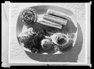 Plate of food including club sandwiches, cakes, a salad and a [sausage roll?] from the All Snack Service, Rainbow Route. Pan American World Airways (PAWA)