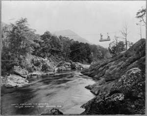 Buller River, West Coast, with cable tram carrying a woman and a child