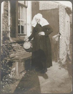 A Dutch woman standing outside a house