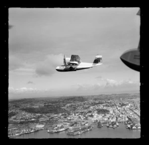 Tourist Air Travel, Grumman Widgeon aircraft in flight over Auckland