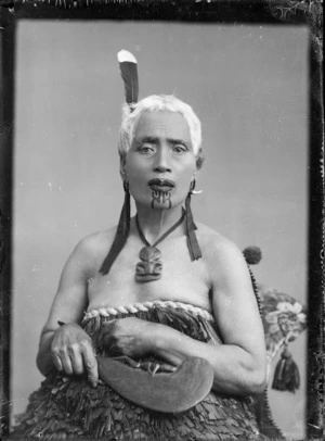 Unidentified Maori woman holding a patu