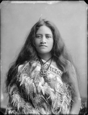 Unidentified young Maori woman wearing a feather cloak