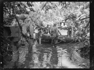 New Zealand soldiers in Vella Lavella, Solomon Islands, during World War II, with a boat abandoned by the Japanese