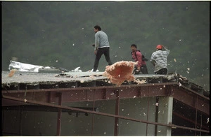 Demolition workers battle with high winds on the roof of a building in Porirua - Photograph taken by John Nicholson