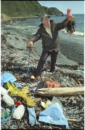 Karori resident Marcus Gotlieb with rubbish at Makara Beach, Wellington - Photograph taken by Ray Pigney