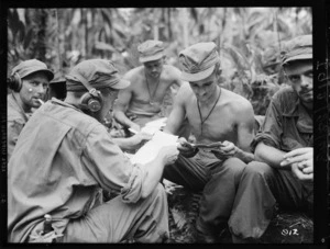 New Zealand soldiers reading letters from home at Vella Lavella, Solomon Islands, during World War II
