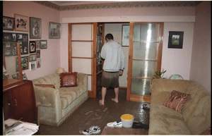 Miramar student Chester Young inside his flood damaged house - Photograph taken by John Nicholson