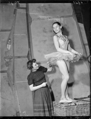 Ballet wardrobe mistress adjusting a dancer's dress